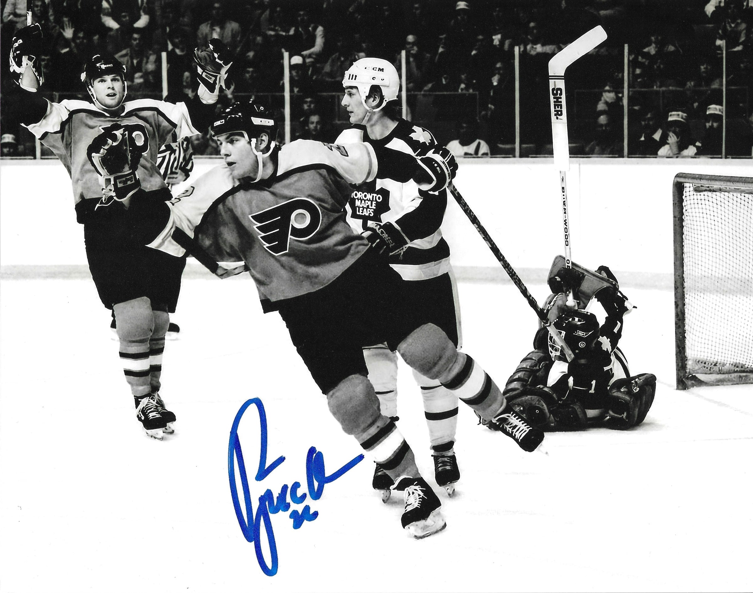 Philadelphia Flyers legend Rick Tocchet celebrating a goal with a visible signature on the photo