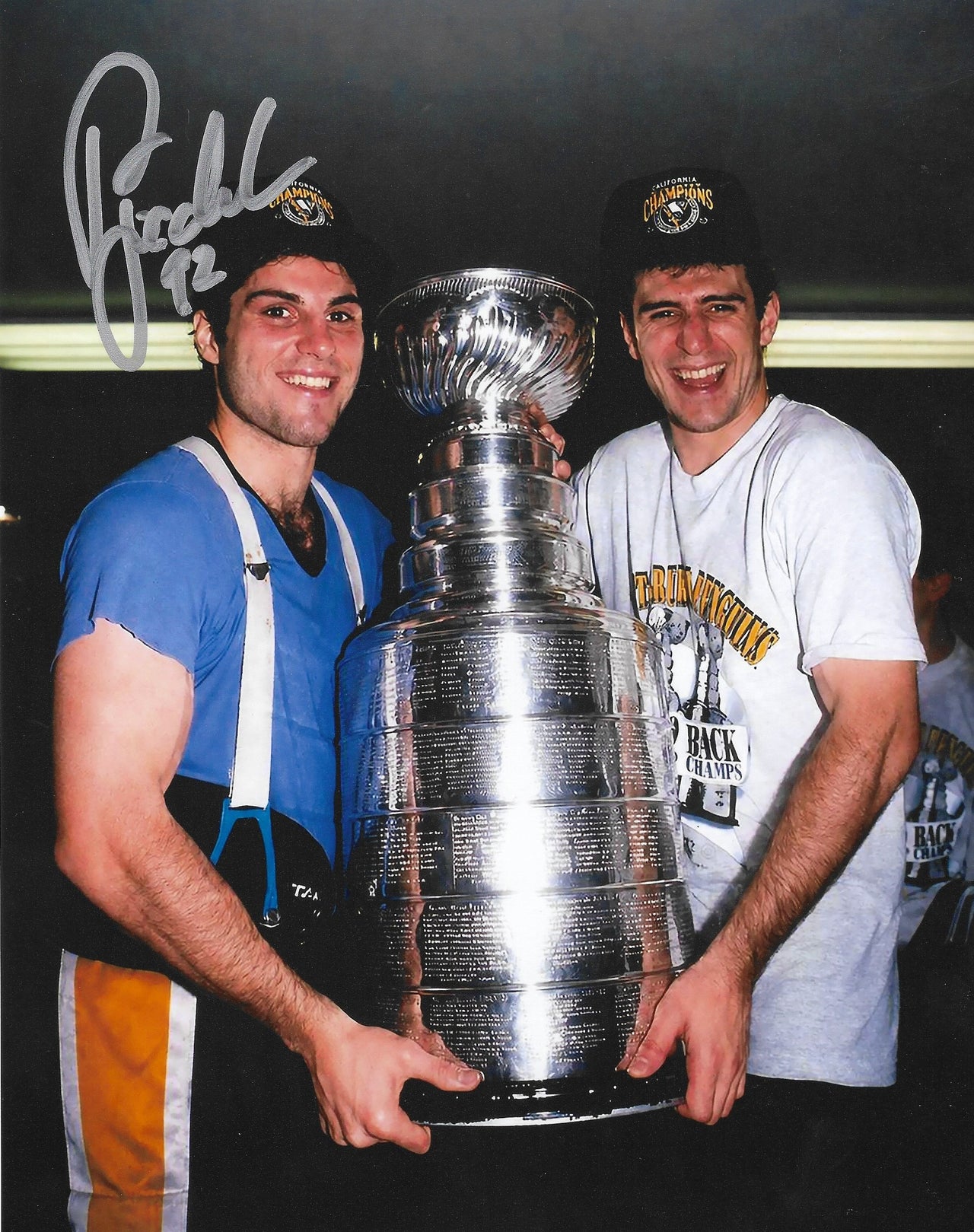 Pittsburgh Penguins legend Rick Tocchet celebrating with the Stanley Cup in 1992 with a visible signature on the photo