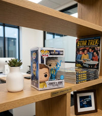 Autographed William Shatner Captain James Kirk Funko Pop sitting on an office shelf with other Star Trek memorabilia