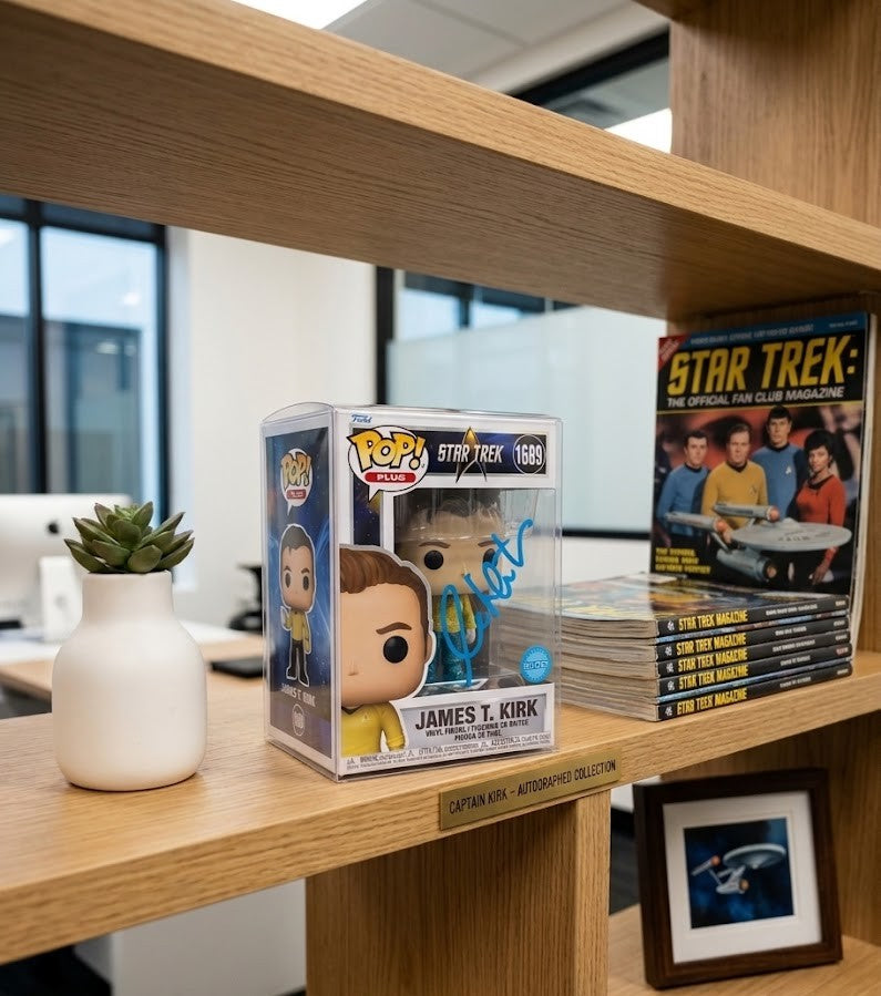 Autographed William Shatner Captain James Kirk Funko Pop sitting on an office shelf with other Star Trek memorabilia