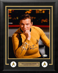 Framed, autographed photo of William Shatner as Captain Kirk from Star Trek, displayed in a black frame and a Star Trek nameplate at the bottom.